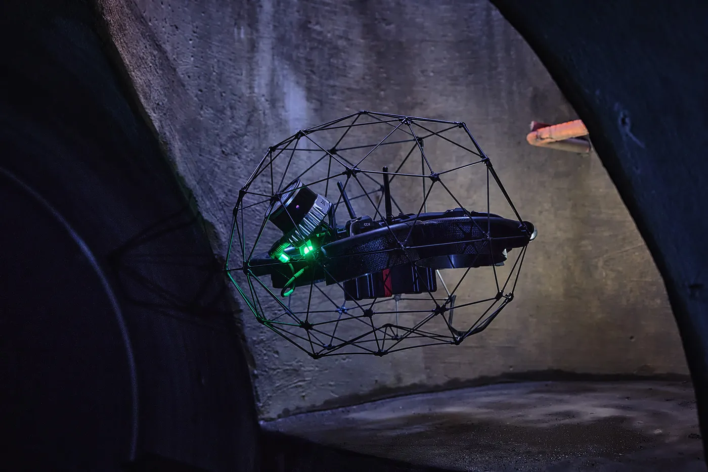 Caged inspection drone inside a sewer shaft