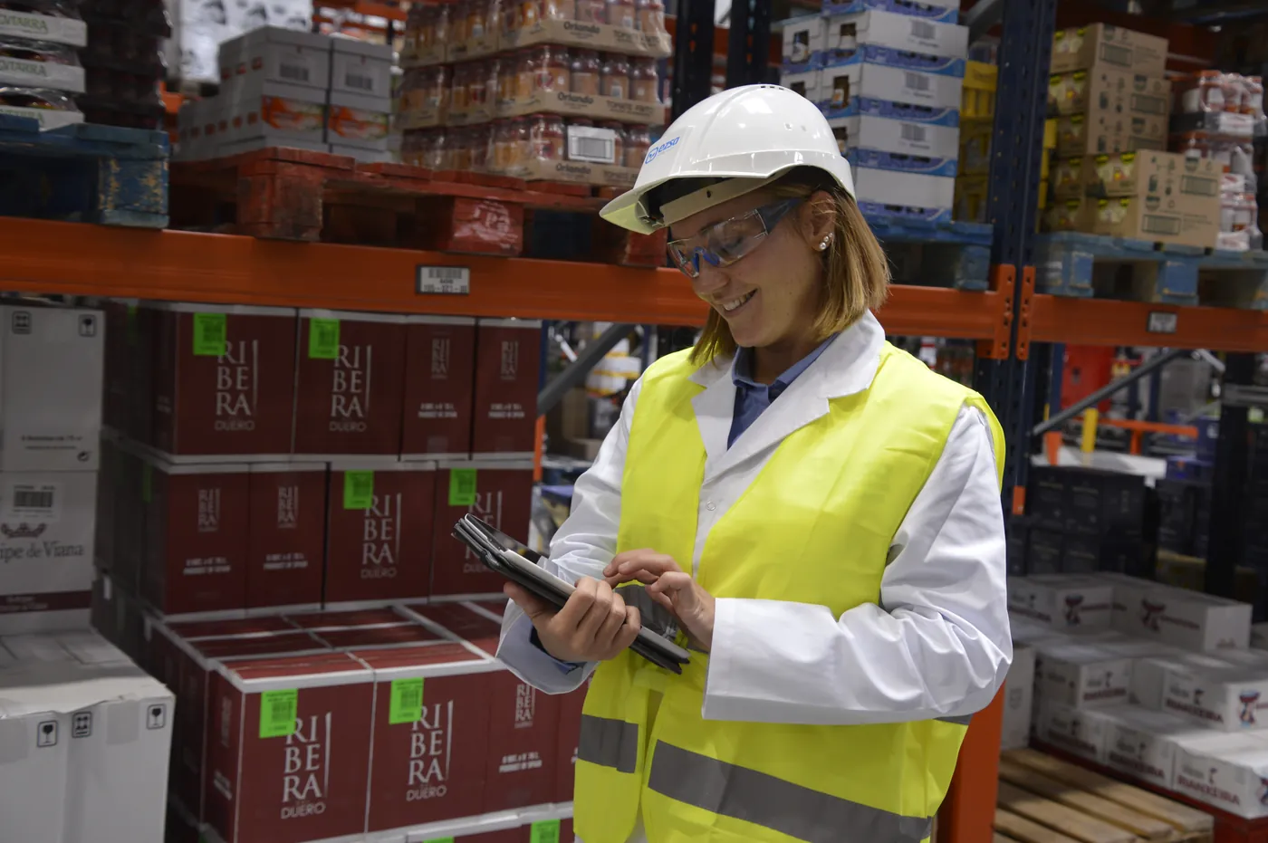 Environmental health specialist checking pest monitoring data in a warehouse