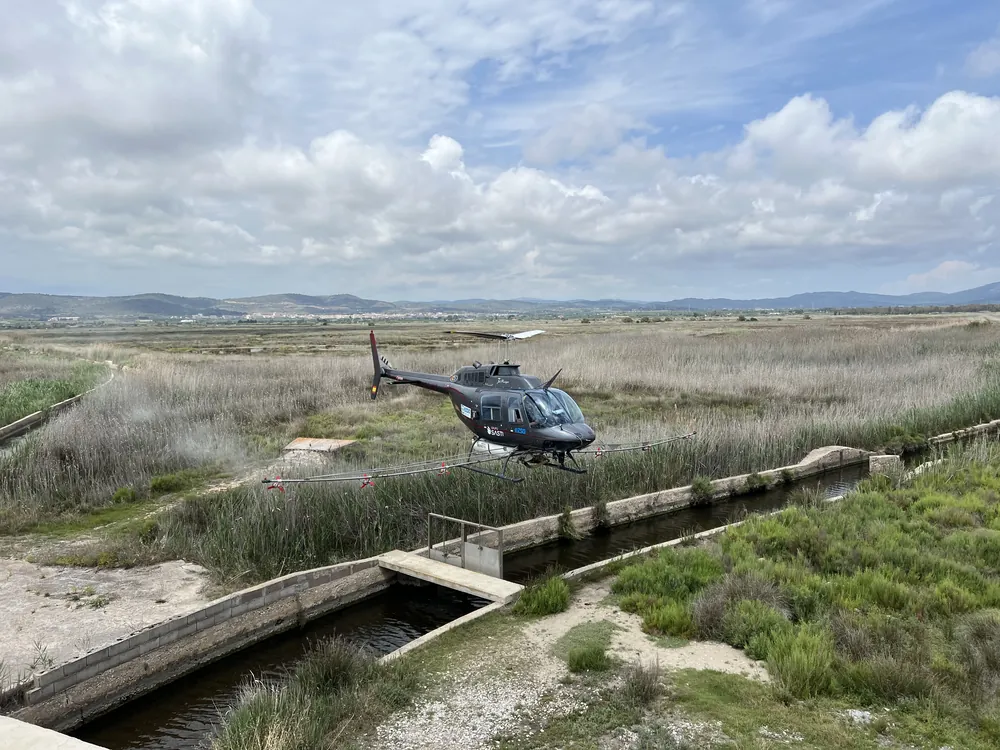 Helicopter treating wetlands