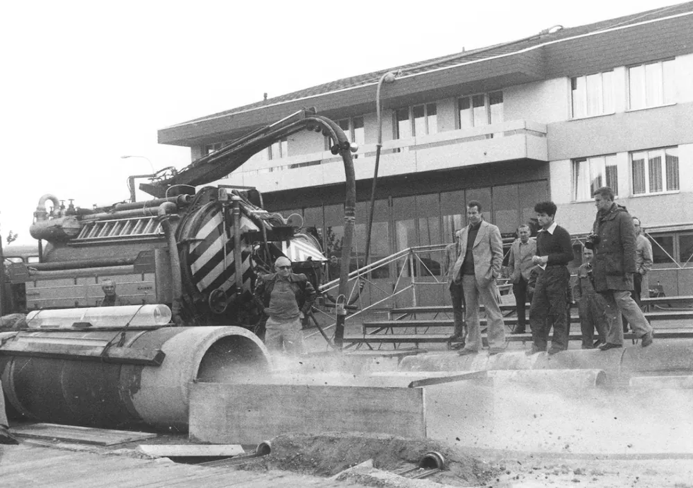 Sewer works watched by onlookers, decades ago