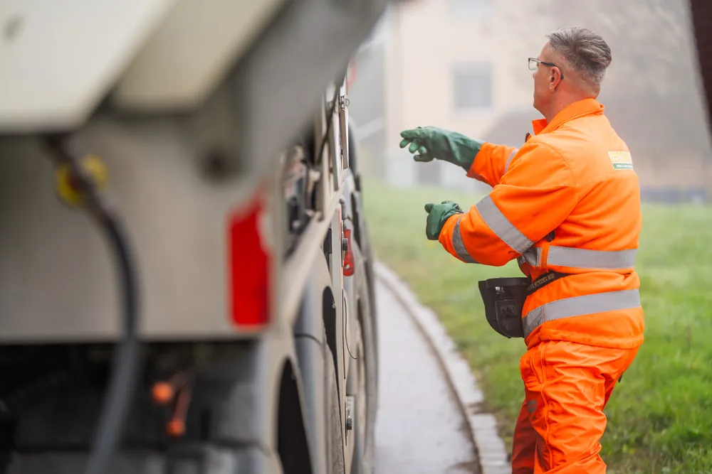 Operator at the side of his cleaning truck