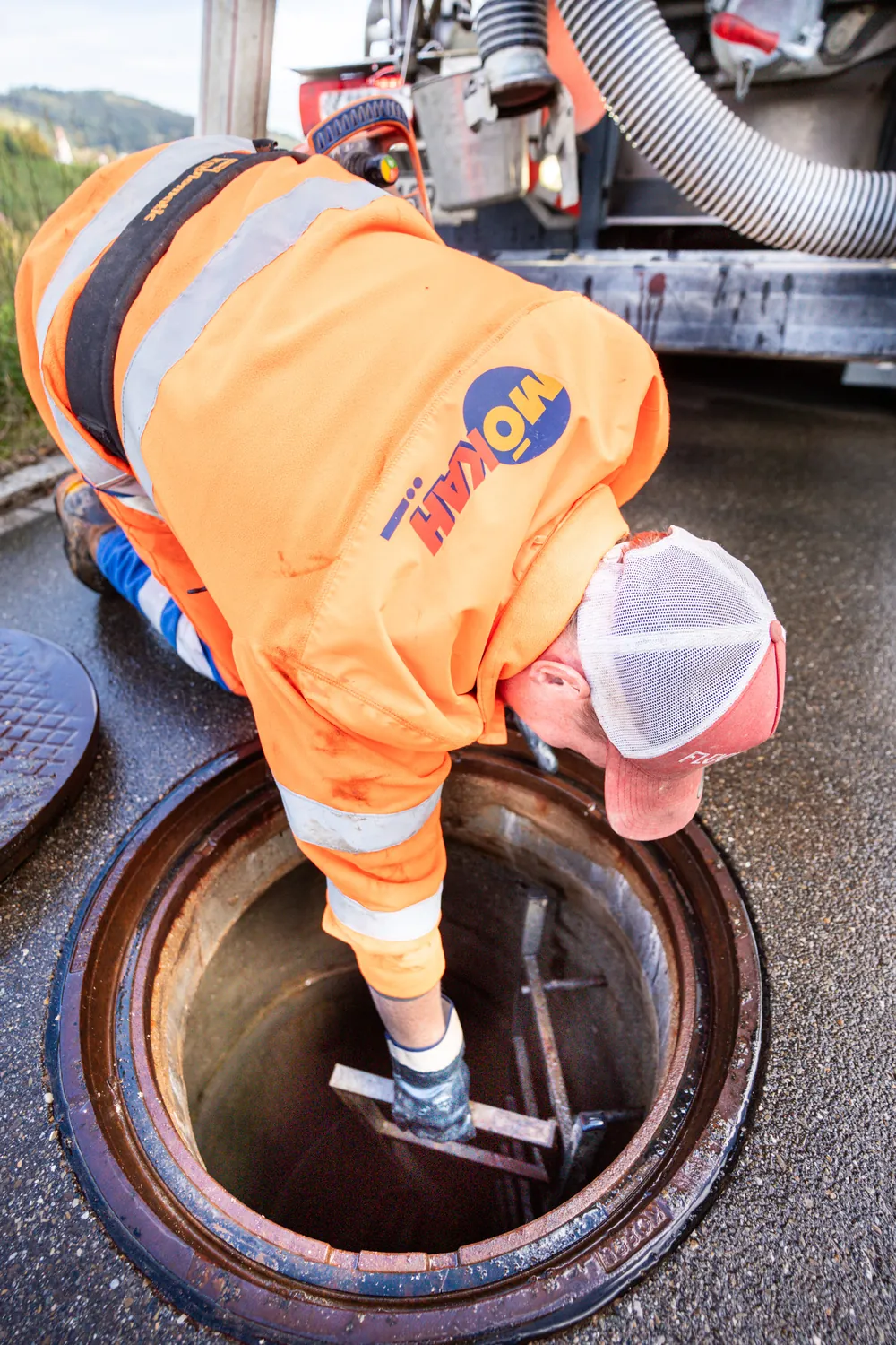 Specialist working at an open manhole