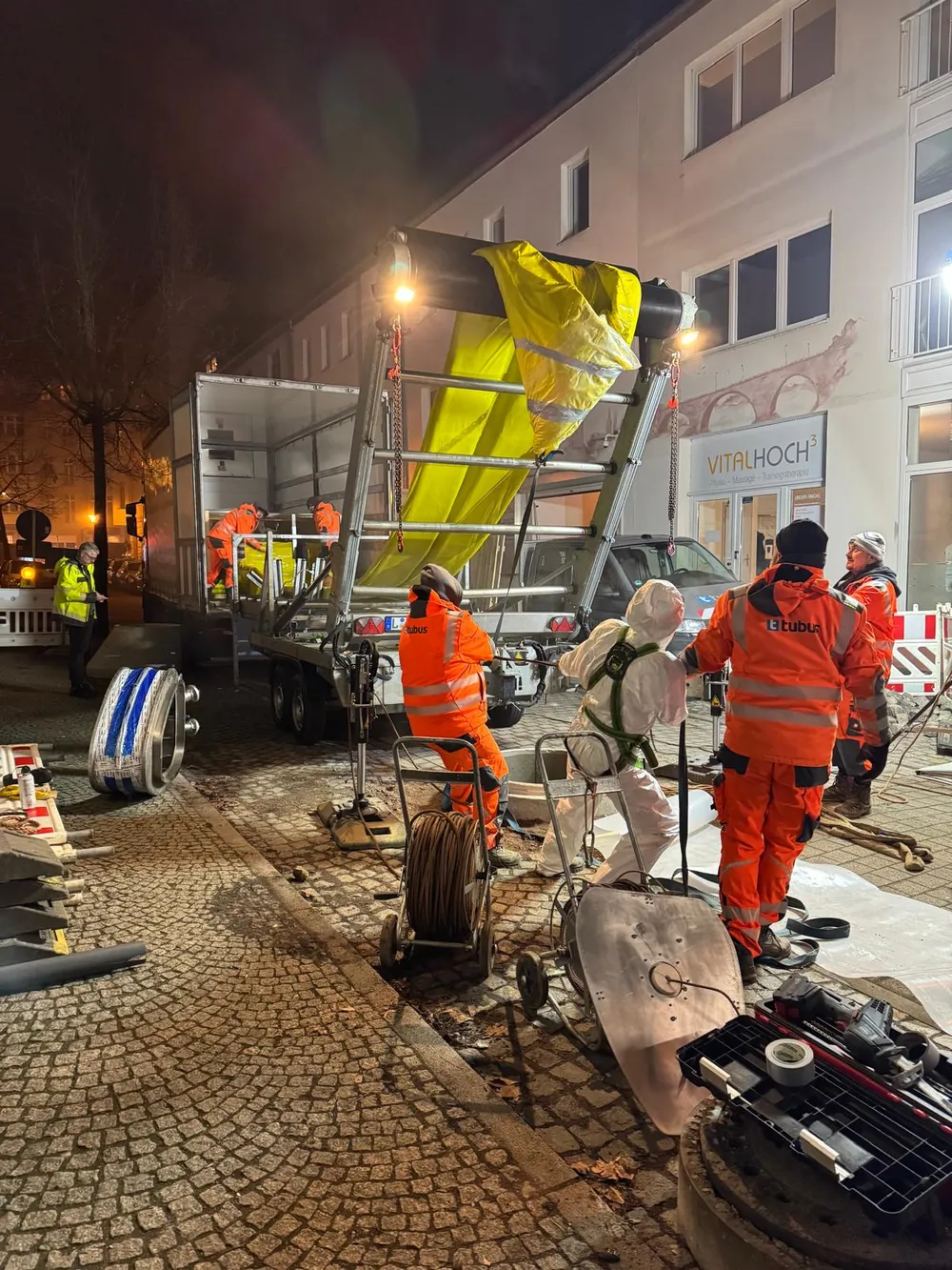 Night-time sewer works in a city street