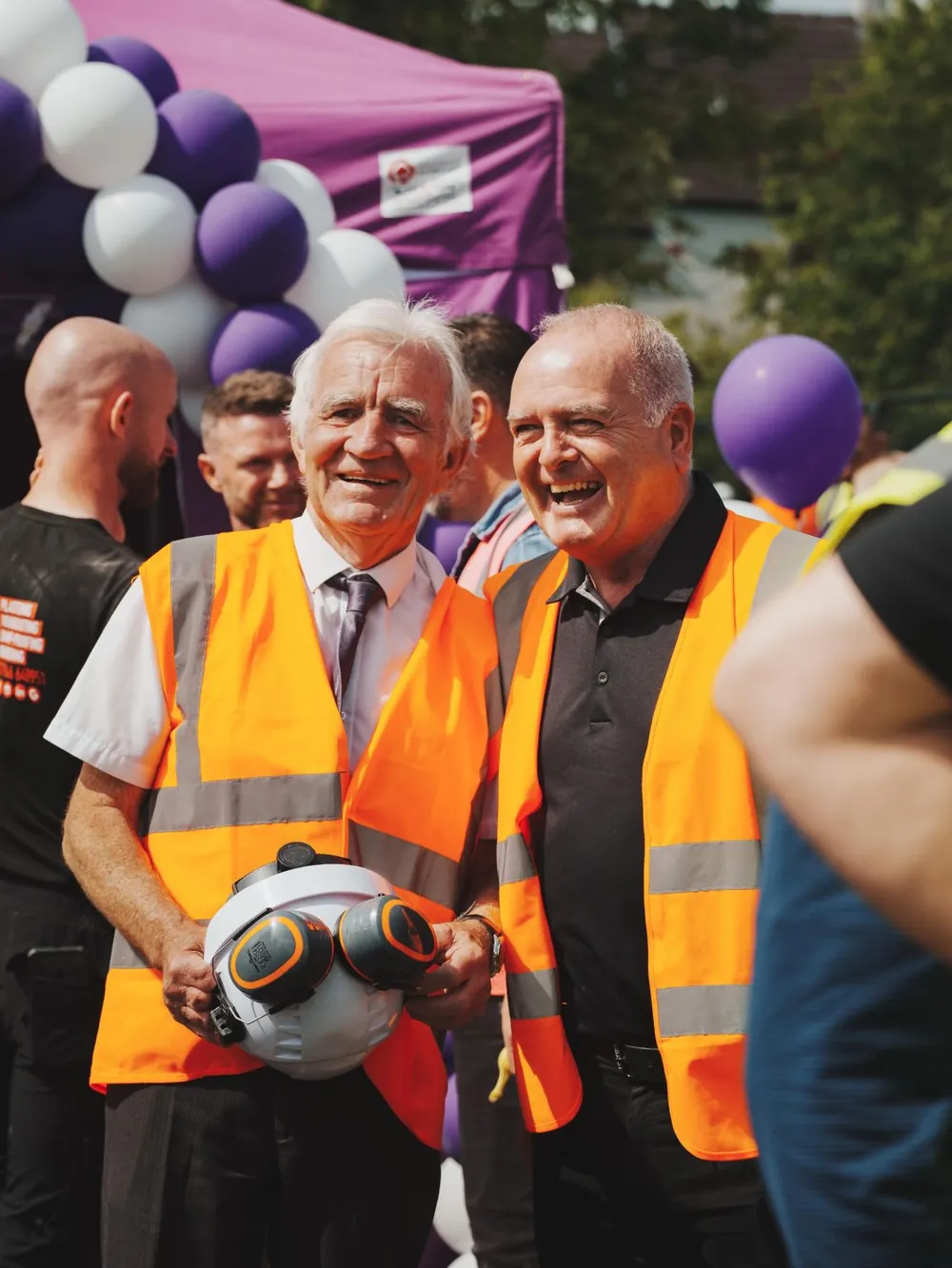 KSG colleagues in high-visibility vests laughing together