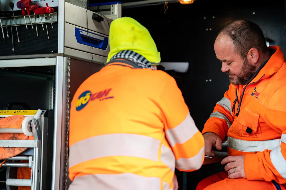 Two KSG specialists working together in their equipment van