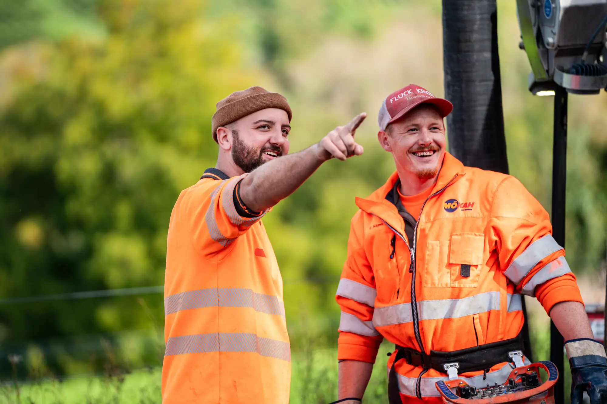 Two smiling KSG sewer specialists on a job site