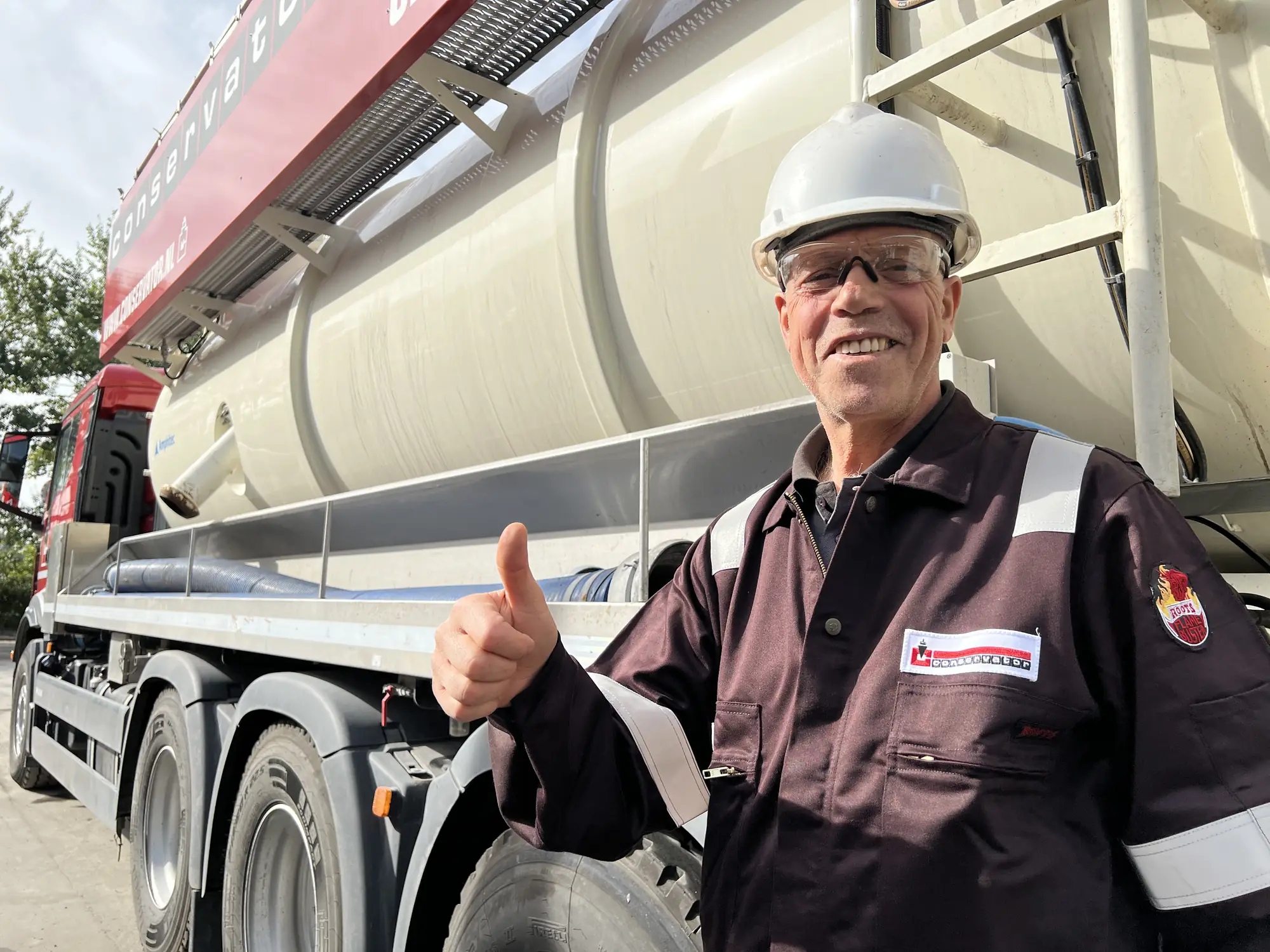 Smiling KSG operator next to his vacuum truck