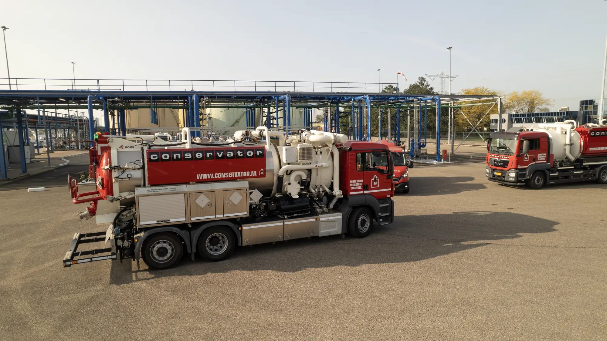 Fleet of KSG industrial cleaning trucks at a chemical plant