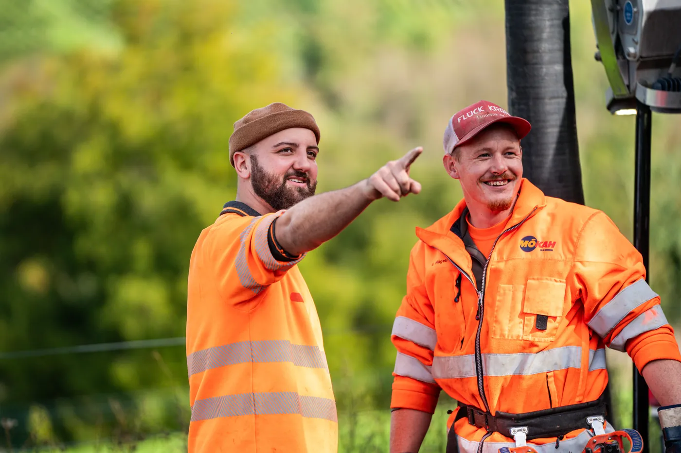 Two KSG operators planning the next step next to their sewer-cleaning truck