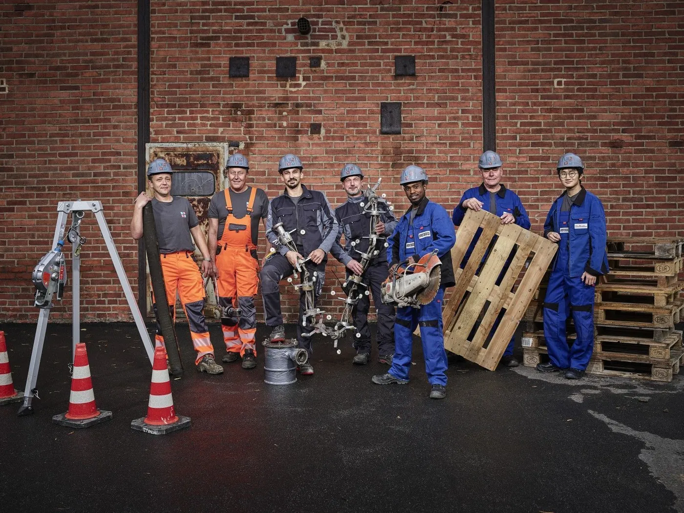 KSG sewer crew with their equipment in front of a brick wall