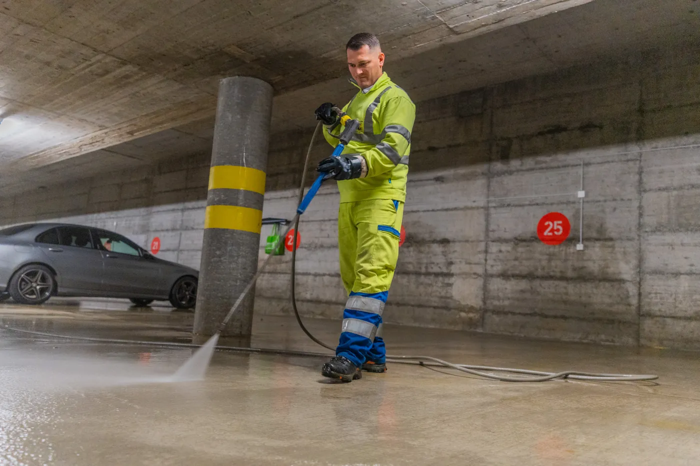 Operator cleaning an underground car park
