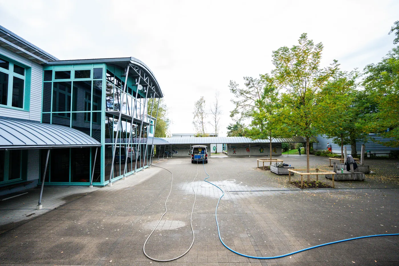 Sewer-cleaning van at work in a school courtyard