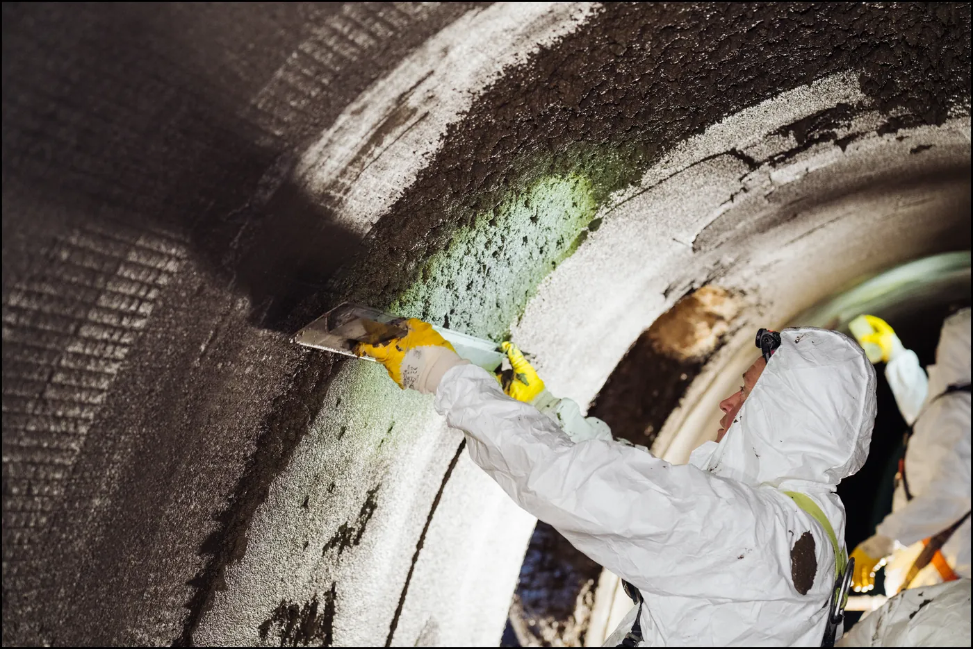 Specialist renovating a walk-in sewer